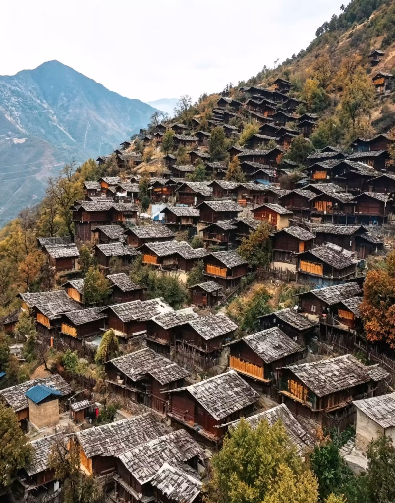 Densely packed wooden houses with stone-weighted plank roofs cover a steep mountainside village in Yunnan, China